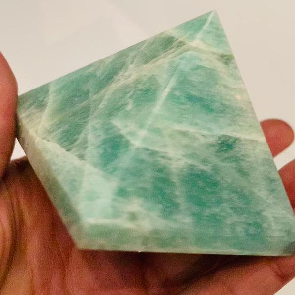 Zoom sur l'amazonite en forme de pyramide, associée aux chakras gorge et coeur